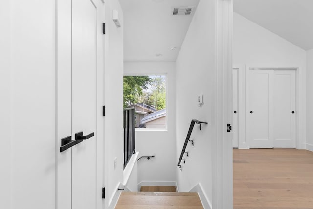 2813 Prado Unit 2, Austin, TX 78702 - stairway featuring wood finished floors and vaulted ceiling