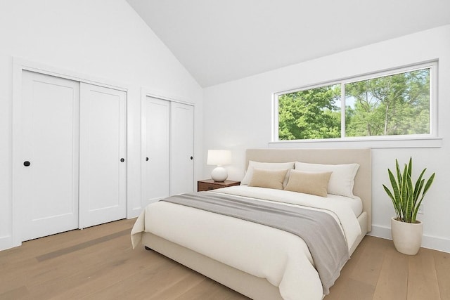 2813 Prado Unit 2, Austin, TX 78702 - bedroom with two closets, vaulted ceiling, and light wood-type flooring