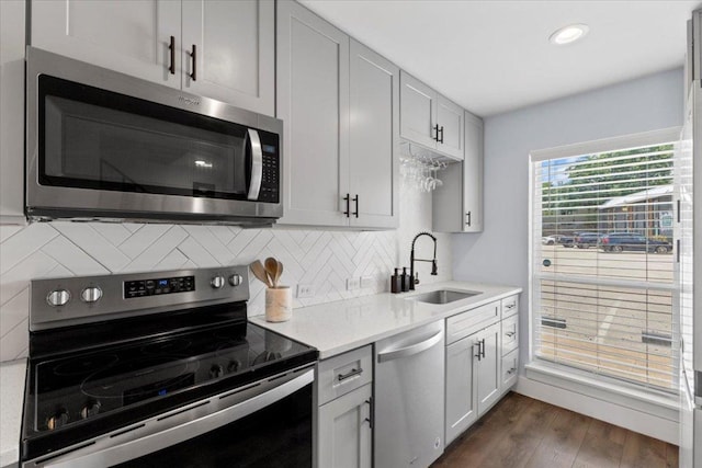 3812 Southway Dr Unit 103, Austin, TX 78704 - kitchen featuring stainless steel appliances, light countertops, tasteful backsplash, dark wood-style flooring, and recessed lighting