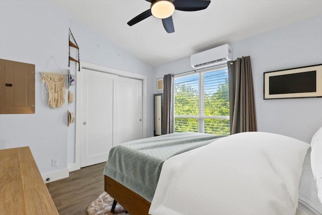 3812 Southway Dr Unit 103, Austin, TX 78704 - bedroom featuring electric panel, a wall mounted AC, wood finished floors, lofted ceiling, and a closet