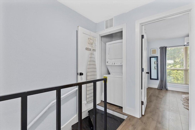 3812 Southway Dr Unit 103, Austin, TX 78704 - hallway with estacked washer and dryer and wood finished floors