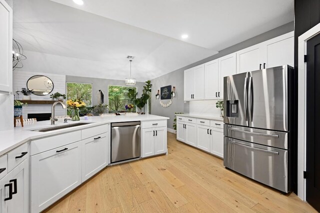3703 Runnels Ct, Austin, TX 78732 - kitchen with stainless steel appliances, light wood-style floors, white cabinetry, light countertops, and recessed lighting