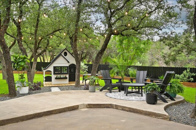3703 Runnels Ct, Austin, TX 78732 - fenced backyard with a patio and an outbuilding