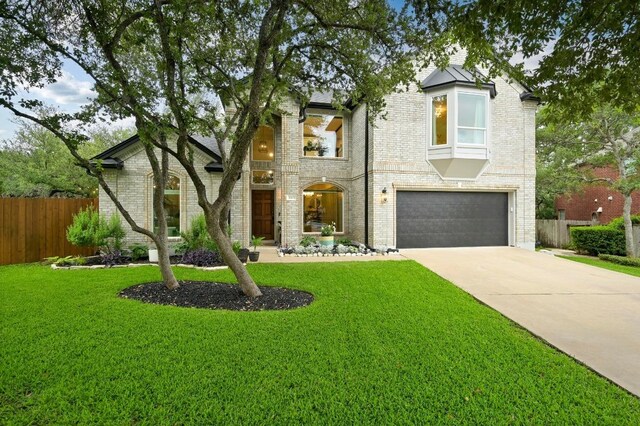 3703 Runnels Ct, Austin, TX 78732 - view of front of home with a garage, concrete driveway, and brick siding