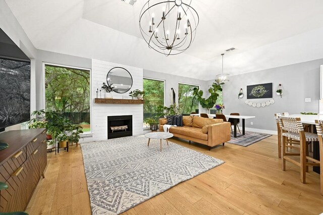 3703 Runnels Ct, Austin, TX 78732 - living area featuring a chandelier, light wood-style flooring, plenty of natural light, and a fireplace