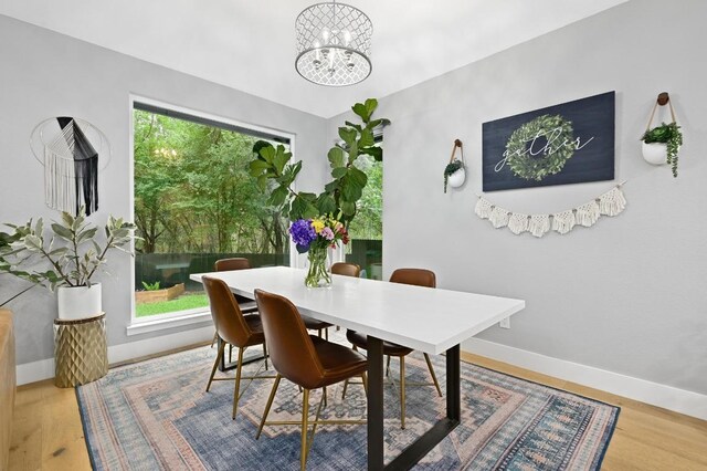 3703 Runnels Ct, Austin, TX 78732 - dining area with a chandelier and wood finished floors