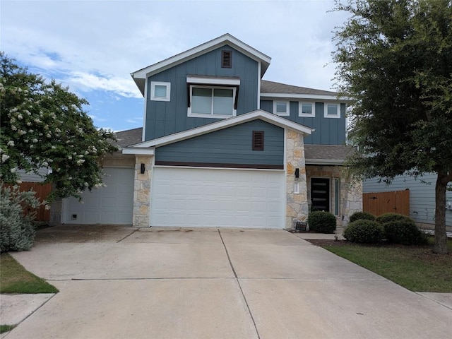 7113 Cherry Beam Path, Austin, TX 78744 - view of front of home featuring board and batten siding, stone siding, concrete driveway, a shingled roof, and an attached garage