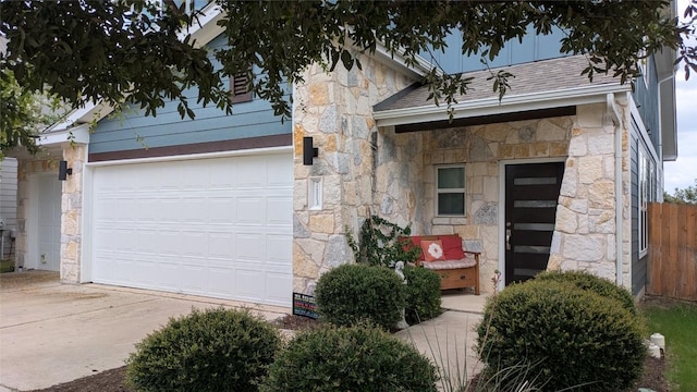 7113 Cherry Beam Path, Austin, TX 78744 - view of front of home with stone siding, driveway, and an attached garage