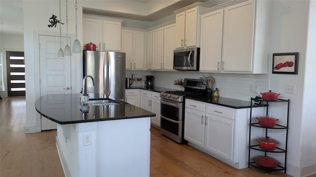 7113 Cherry Beam Path, Austin, TX 78744 - kitchen with stainless steel appliances, backsplash, dark countertops, and light wood-style floors