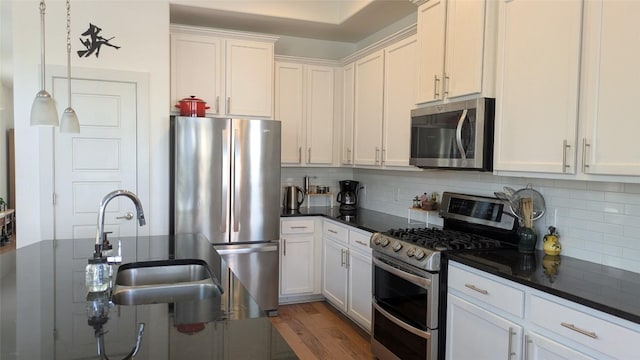 7113 Cherry Beam Path, Austin, TX 78744 - kitchen with stainless steel appliances, dark countertops, backsplash, and white cabinets