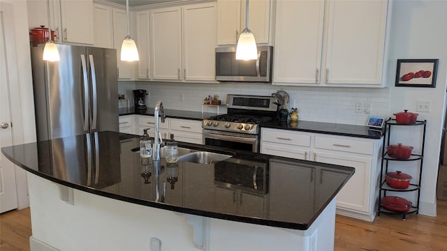 7113 Cherry Beam Path, Austin, TX 78744 - kitchen featuring stainless steel appliances, light wood-style flooring, and decorative backsplash