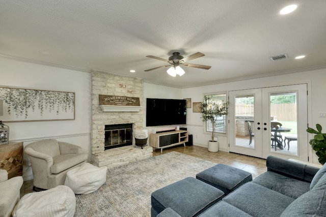 2018 Shadowbrook Cir, Round Rock, TX 78681 - living room featuring crown molding, ceiling fan, french doors, recessed lighting, and a stone fireplace