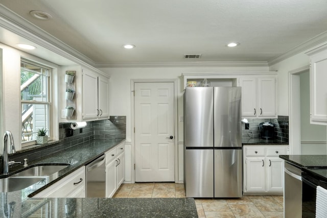 2018 Shadowbrook Cir, Round Rock, TX 78681 - kitchen with stainless steel appliances, white cabinetry, tasteful backsplash, ornamental molding, and recessed lighting