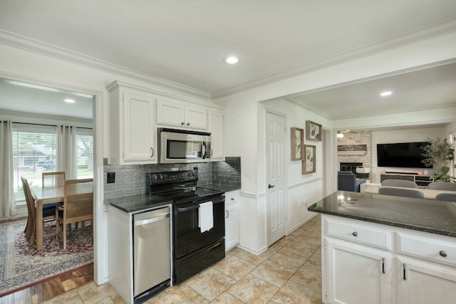 2018 Shadowbrook Cir, Round Rock, TX 78681 - kitchen featuring appliances with stainless steel finishes, white cabinets, decorative backsplash, a fireplace, and dark stone countertops