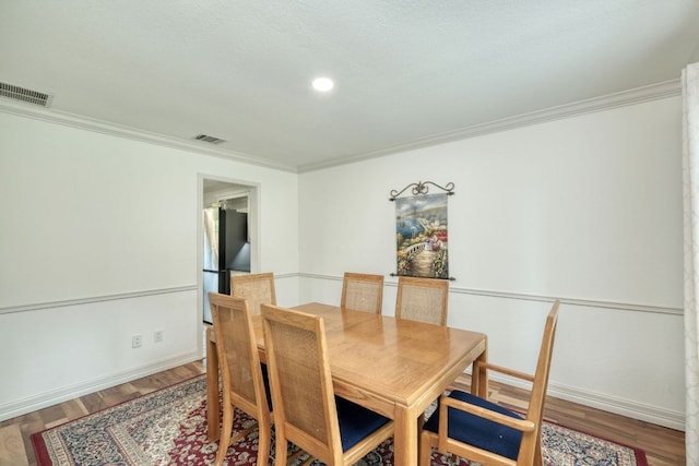 2018 Shadowbrook Cir, Round Rock, TX 78681 - dining area featuring wood finished floors, crown molding, and recessed lighting