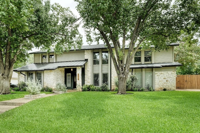 2018 Shadowbrook Cir, Round Rock, TX 78681 - view of front of home with stone siding, a standing seam roof, and a metal roof