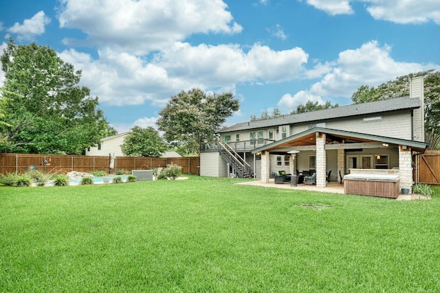2018 Shadowbrook Cir, Round Rock, TX 78681 - rear view of property with stairway, an outdoor living space, a fenced backyard, a patio, and a hot tub