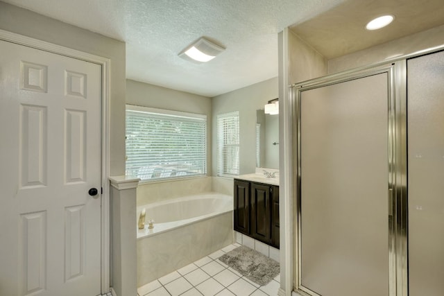 2018 Shadowbrook Cir, Round Rock, TX 78681 - bathroom featuring a garden tub, a stall shower, vanity, tile patterned flooring, and a textured ceiling