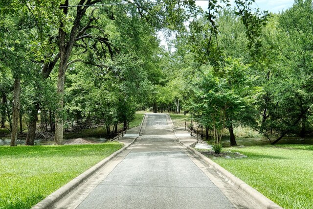 2018 Shadowbrook Cir, Round Rock, TX 78681 - surrounding community with a yard and driveway