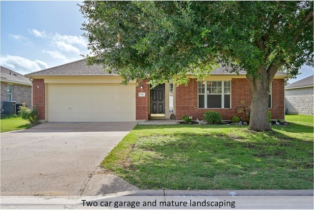118 Lone Star Blvd, Hutto, TX 78634 - view of front of house with a garage, a front lawn, brick siding, and concrete driveway