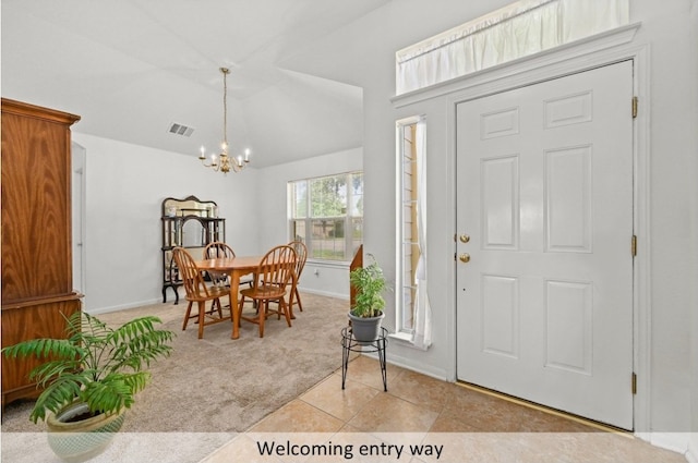 118 Lone Star Blvd, Hutto, TX 78634 - entryway with a chandelier, light carpet, light tile patterned floors, and vaulted ceiling