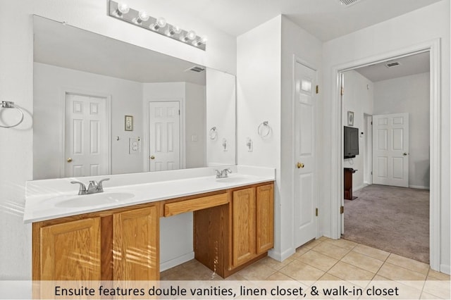 118 Lone Star Blvd, Hutto, TX 78634 - bathroom featuring double vanity and tile patterned flooring