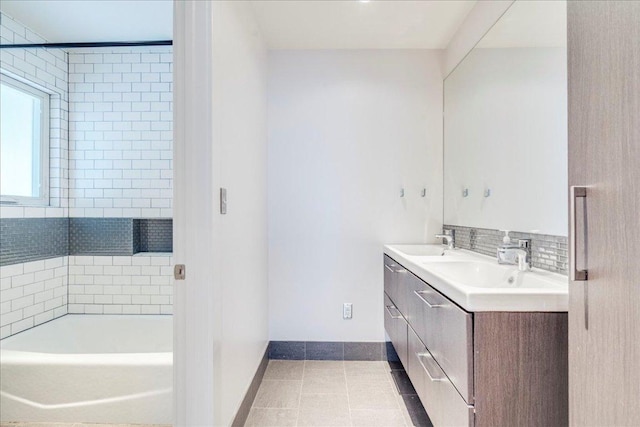 6602 Daugherty St, Austin, TX 78757 - full bathroom with tile patterned floors, double vanity, a tub, and backsplash