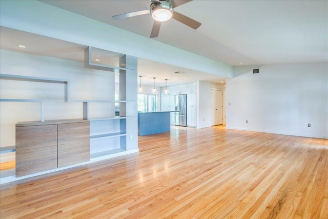 6602 Daugherty St, Austin, TX 78757 - unfurnished living room featuring light wood-style flooring, a ceiling fan, and recessed lighting