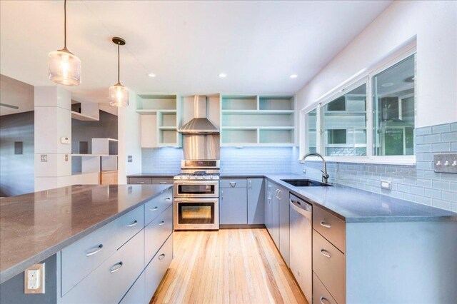 6602 Daugherty St, Austin, TX 78757 - kitchen featuring wall chimney range hood, stainless steel appliances, open shelves, tasteful backsplash, and recessed lighting