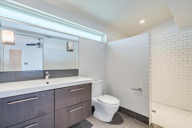 6602 Daugherty St, Austin, TX 78757 - bathroom featuring vanity, tile patterned flooring, tiled shower, tasteful backsplash, and ceiling fan