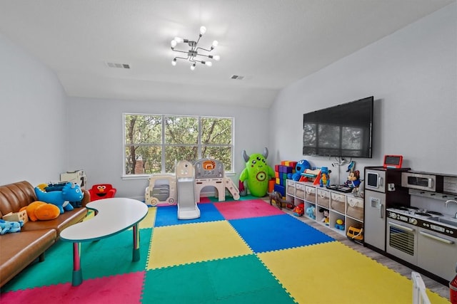 2108 Ariella Dr, Cedar Park, TX 78613 - playroom with lofted ceiling, a chandelier, and wood finished floors