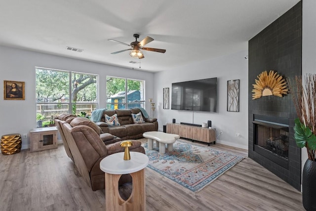 2108 Ariella Dr, Cedar Park, TX 78613 - living area featuring a ceiling fan, wood finished floors, and a fireplace