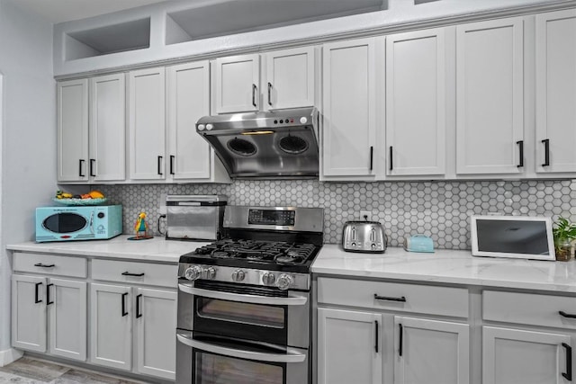 2108 Ariella Dr, Cedar Park, TX 78613 - kitchen featuring double oven range, exhaust hood, backsplash, and light stone counters