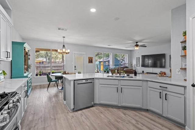 2108 Ariella Dr, Cedar Park, TX 78613 - kitchen with stainless steel appliances, light countertops, a peninsula, a ceiling fan, and a chandelier