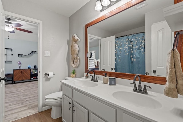 2108 Ariella Dr, Cedar Park, TX 78613 - bathroom featuring wood finished floors, double vanity, and a ceiling fan