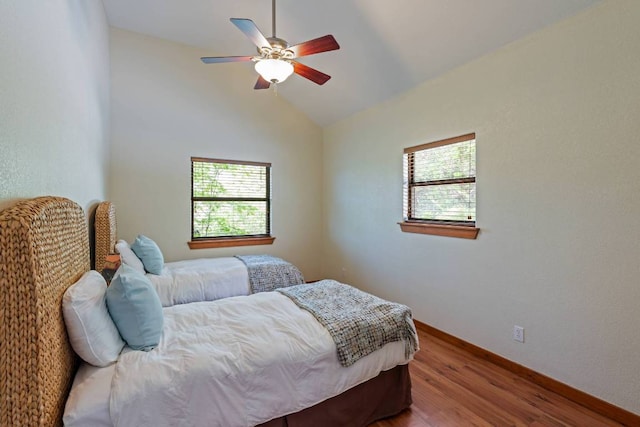 8152 Breeze Way, Jonestown, TX 78645 - bedroom with wood finished floors, multiple windows, lofted ceiling, and ceiling fan