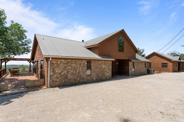 8152 Breeze Way, Jonestown, TX 78645 - view of front of property with stone siding and a metal roof