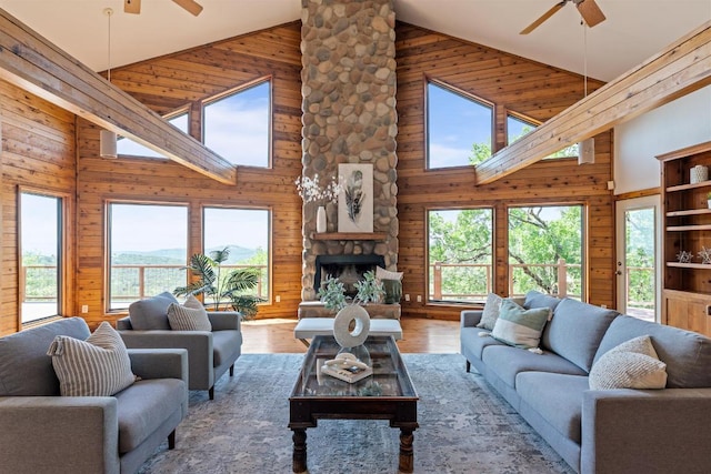 8152 Breeze Way, Jonestown, TX 78645 - living area with ceiling fan, high vaulted ceiling, healthy amount of natural light, wooden walls, and wood finished floors