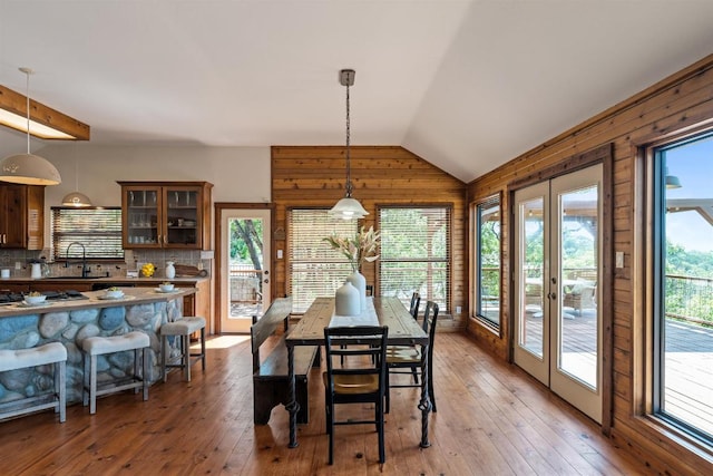 8152 Breeze Way, Jonestown, TX 78645 - dining room with light wood-style floors, wooden walls, and lofted ceiling