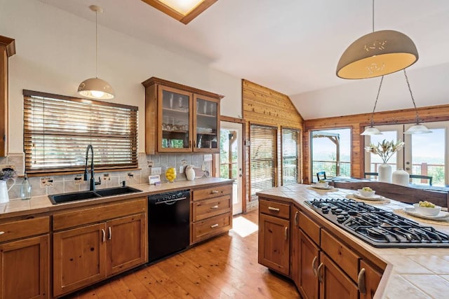 8152 Breeze Way, Jonestown, TX 78645 - kitchen with dishwasher, stainless steel gas cooktop, tile countertops, decorative light fixtures, and lofted ceiling