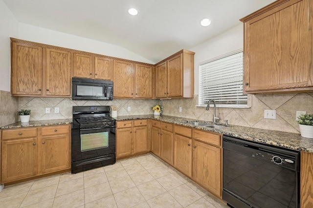 20209 Harrier Flight Trl, Pflugerville, TX 78660 - kitchen with black appliances, lofted ceiling, dark stone counters, tasteful backsplash, and light tile patterned flooring