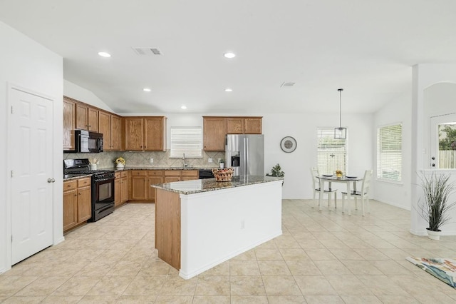 20209 Harrier Flight Trl, Pflugerville, TX 78660 - kitchen with black appliances, vaulted ceiling, backsplash, dark stone countertops, and a center island