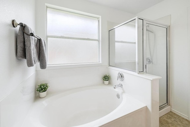20209 Harrier Flight Trl, Pflugerville, TX 78660 - bathroom with a stall shower, a garden tub, and tile patterned floors