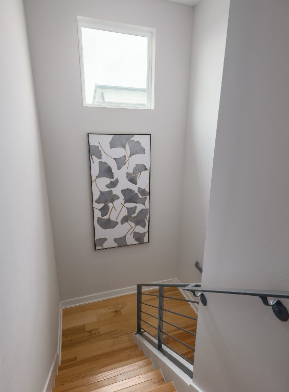 7013 Boyle Dr, Austin, TX 78724 - stairs with wood finished floors and baseboards