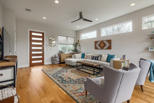 7013 Boyle Dr, Austin, TX 78724 - living area featuring wood finished floors, ceiling fan, and recessed lighting