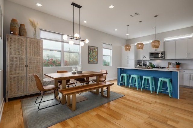 7013 Boyle Dr, Austin, TX 78724 - dining area featuring light wood finished floors and recessed lighting