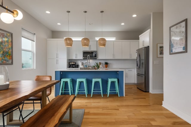 7013 Boyle Dr, Austin, TX 78724 - kitchen with appliances with stainless steel finishes, white cabinetry, light wood finished floors, and recessed lighting