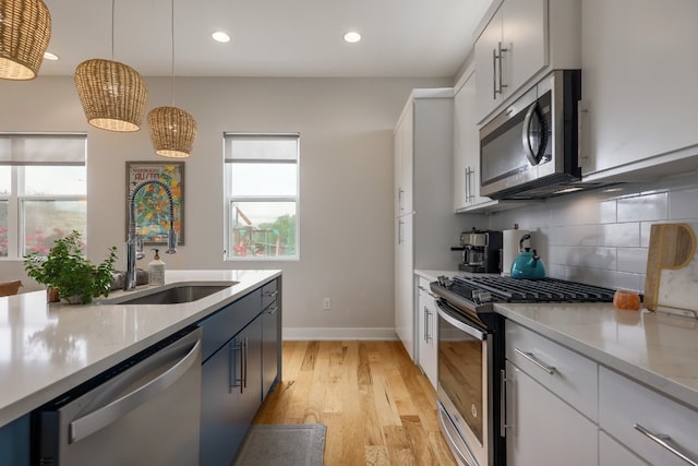 7013 Boyle Dr, Austin, TX 78724 - kitchen with appliances with stainless steel finishes, light countertops, decorative backsplash, decorative light fixtures, and recessed lighting