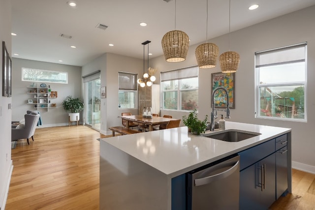 7013 Boyle Dr, Austin, TX 78724 - kitchen with dishwasher, light wood finished floors, a kitchen island with sink, hanging light fixtures, and recessed lighting