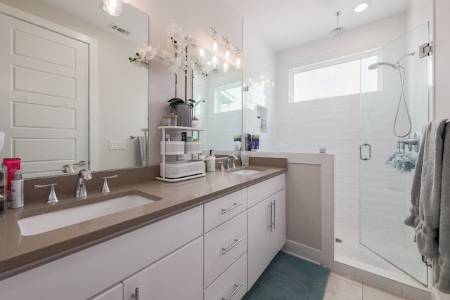 7013 Boyle Dr, Austin, TX 78724 - bathroom featuring double vanity, a shower stall, and tile patterned flooring